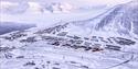 Longyearbyen and nearby mountains seen from above during winter