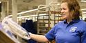 An employee in Svalbardbutikken stocking bread shelves in the store