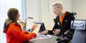 An employee helping a guest at the front desk