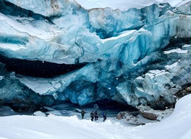 several people standing in front of a glacier 