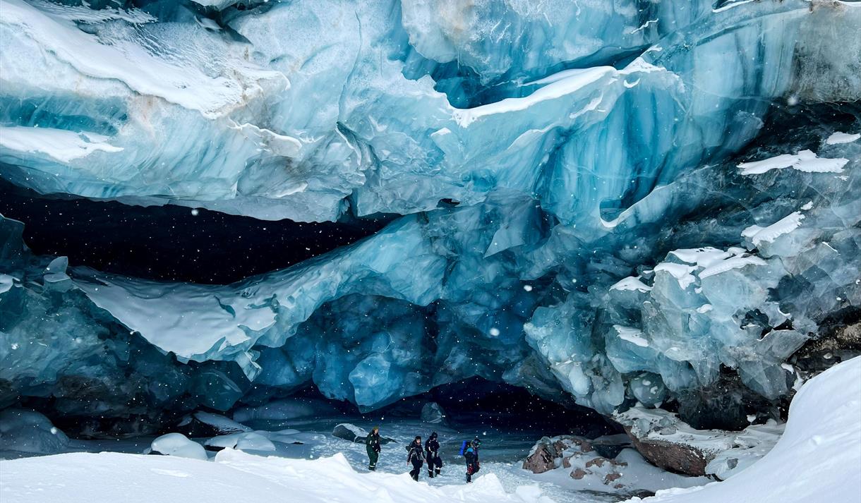 several people standing in front of a glacier