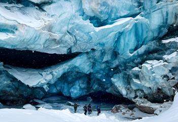 several people standing in front of a glacier