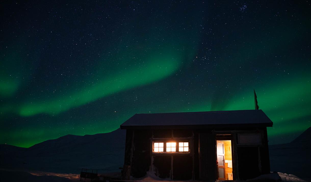 The Foxdal cabin with Northern Lights in the background