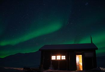 The Foxdal cabin with Northern Lights in the background