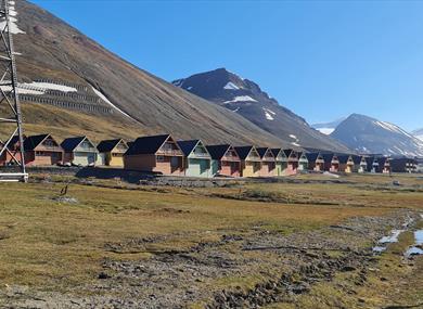 Colourful houses in Longyearbyen with mountains in the background