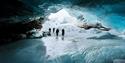 People inside a crystalblue icecave