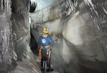 A person inside an ice cave