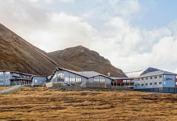 Hotellet Radisson Blu Polar Hotel sett utenfra med fjell i bakgrunnen