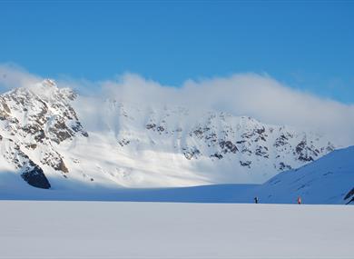 Skiers in a mountainous landscape