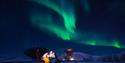 Couple kissing under the northern lights