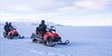 Guests on their snowmobiles
