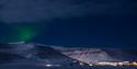 Faint northern lights shining above Longyearbyen
