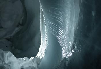 Ice formations inside a dark ice cave