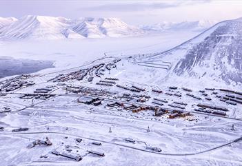 Longyearbyen and nearby mountains seen from above during winter