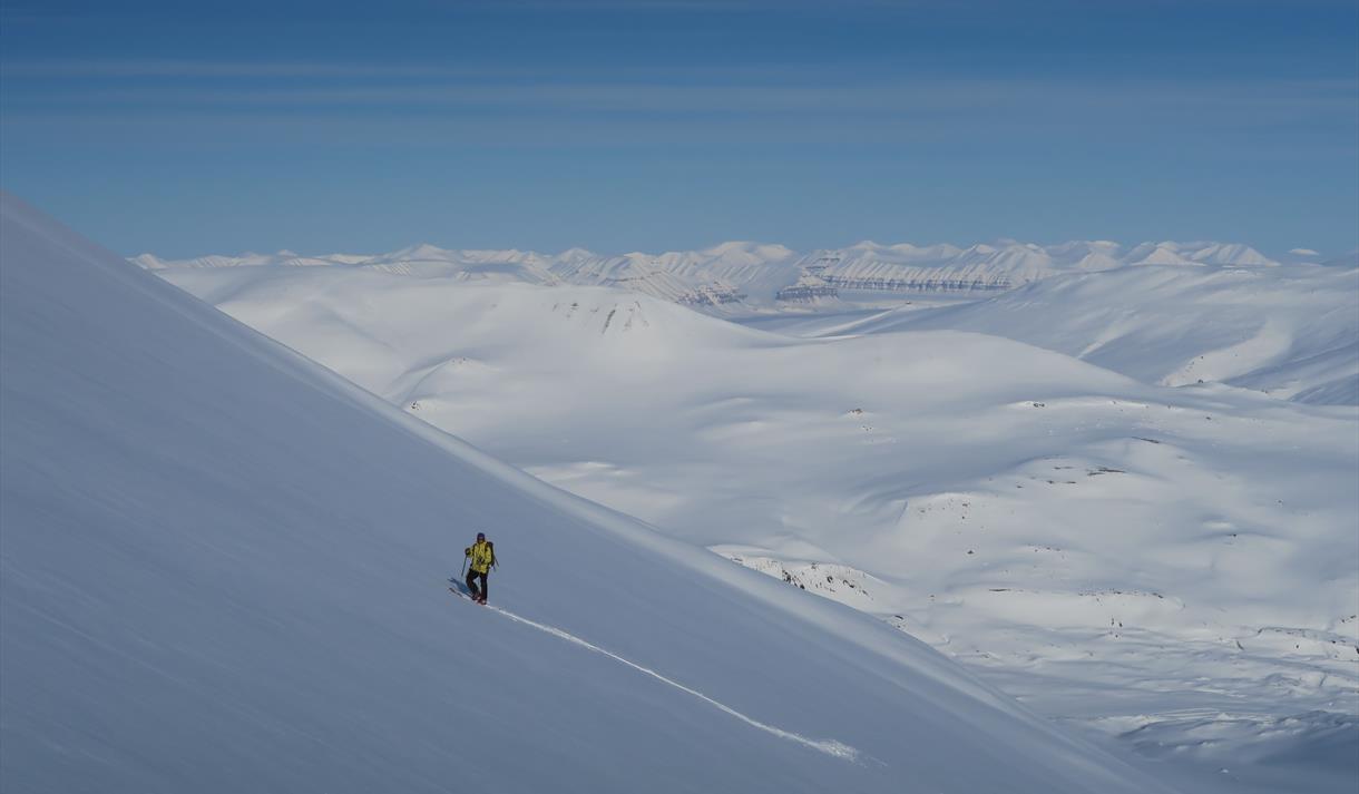 Skier traversing a mountainside