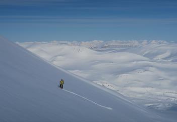 Skier traversing a mountainside