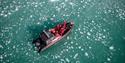 Gjester ombord en båt som seiler blant isklumper i sjøen