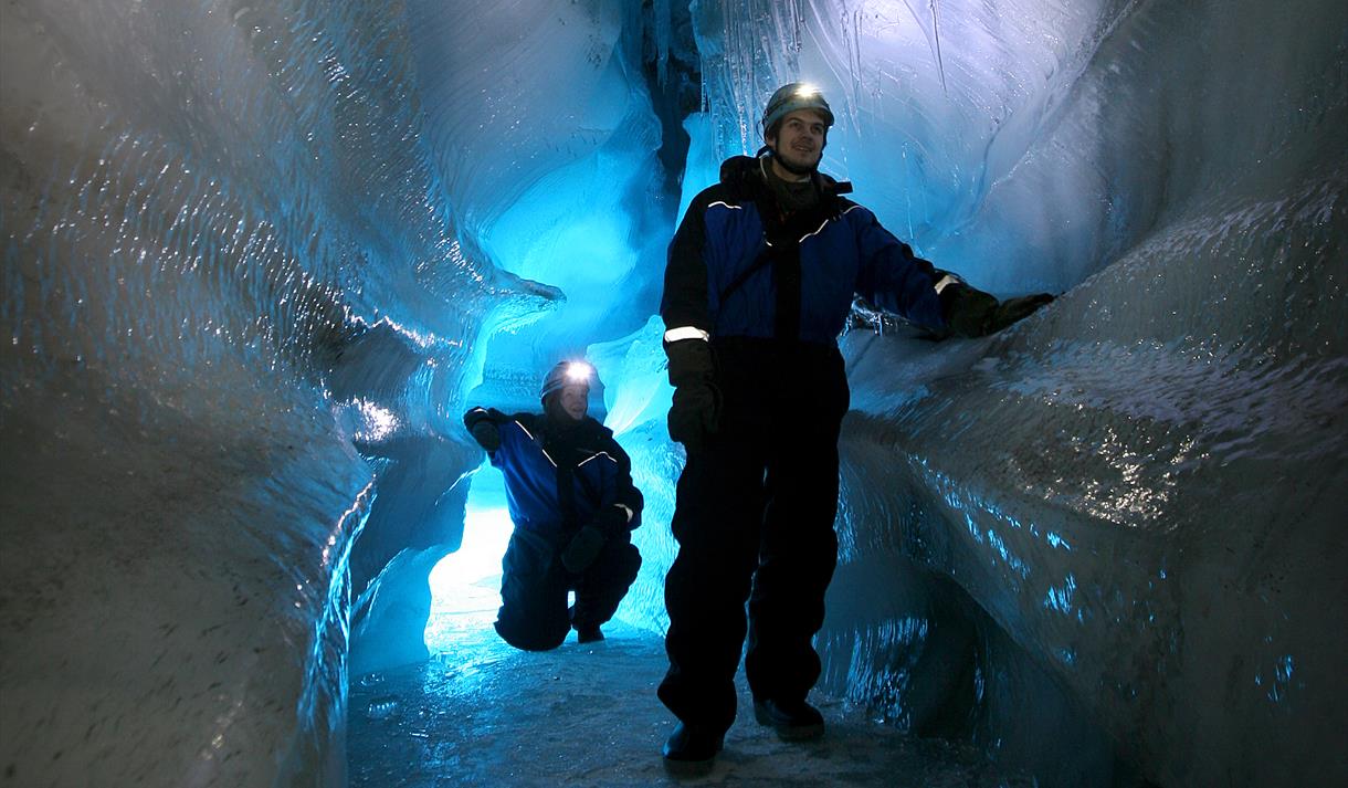 Two people in an ice cave