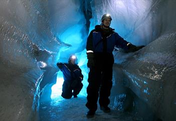 Two people in an ice cave