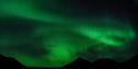 Northern lights shining above mountains