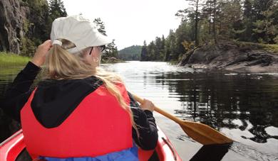 girl paddling in a kayak on Herrevasdraget in Bamble