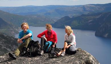 group of 3 sitting on a peak