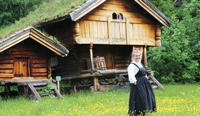 lady in front of storage shed at Tuddal bygdetun