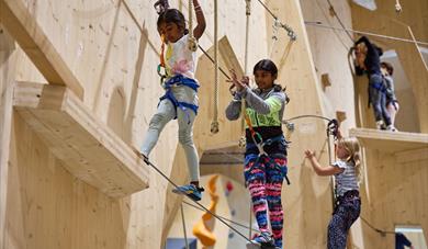 children climbing on "Høyt under Taket" in Skien