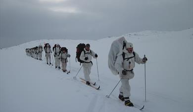 group of men on skis dressed in white