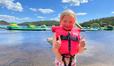 little girl in front of the water park at Hulfjell family park