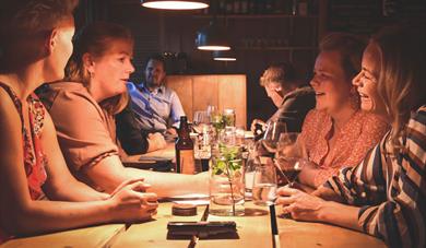 gruppe med venner spiser på Bjaaland Bygderestaurant i Morgedal