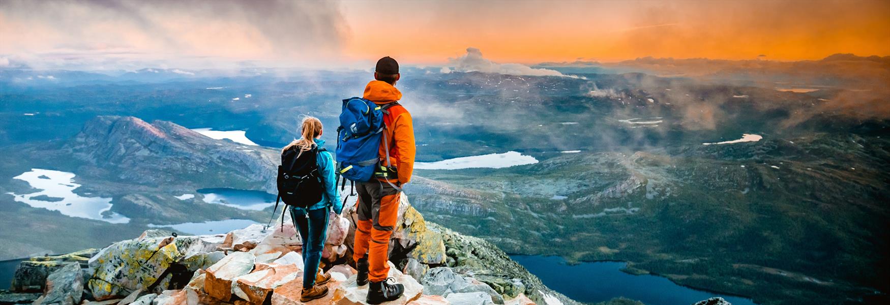 couple standing on top of Gaustatoppen