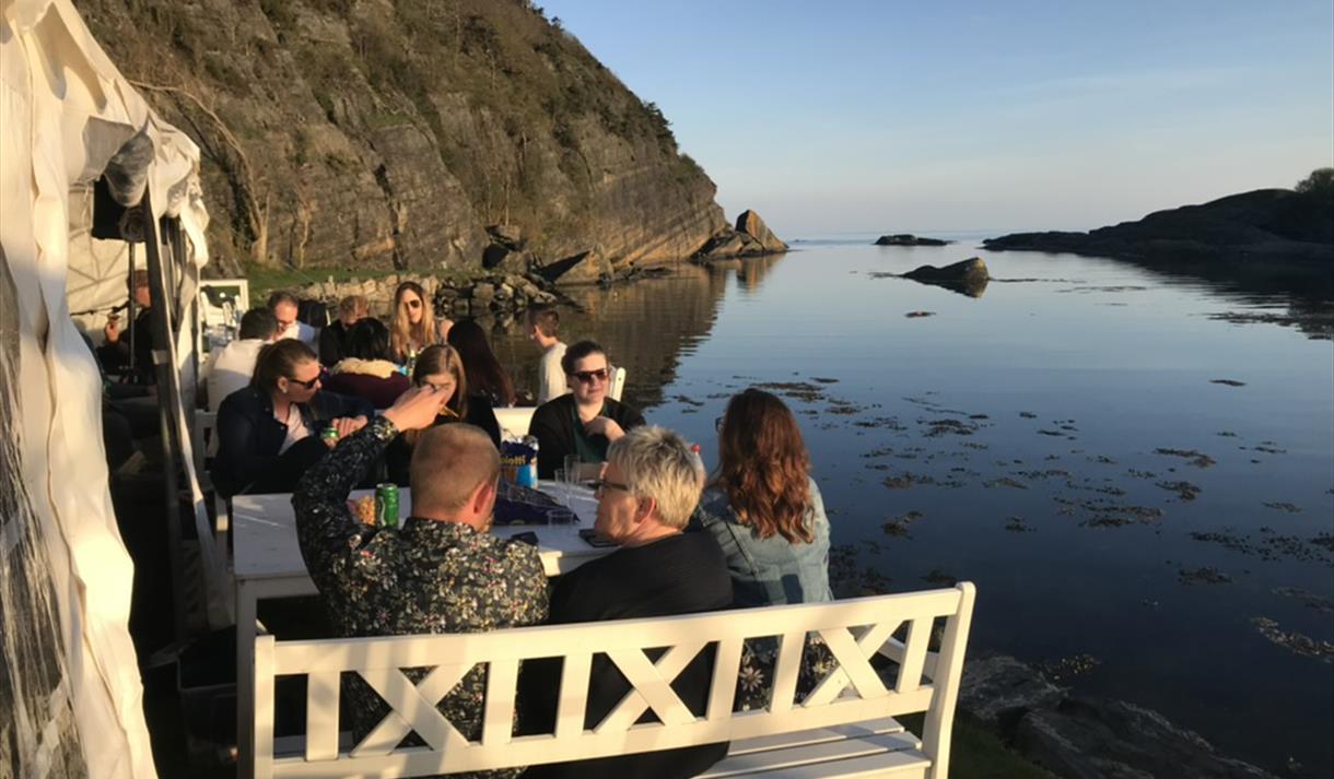 Group eating by the sea