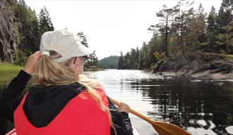 girl paddling in a kayak on Herrevasdraget in Bamble