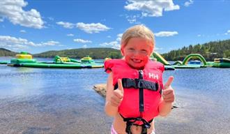 little girl in front of the water park at Hulfjell family park