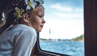 girl looks out of the window on the boat