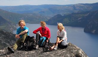 group of 3 sitting on a peak