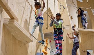 children climbing on "Høyt under Taket" in Skien