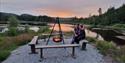 couple sitting by the campfire at Lille Nakksjø cabin farm in Villmarkseventyret