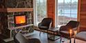 living room with beautiful fireplace in cottage Holmvann