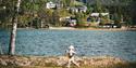 child by lake Morgedalsvannet at Morgedal Camping & Lavvo Glamping
