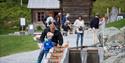 little boy locks a boat on the miniature version of the telemark canal in the canal park at Vest-Telemark Museum in Eidsborg