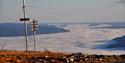 View from Krintofjell at Lifjell, a summit that reaches 930 meters above sea level. A layer of clouds and fog is lying above the villages below.