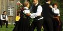 people in bunad dancing at the Tinn Museum