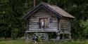 old norwegian house "stabbur" with to boys playing at Drangedal bygdetun