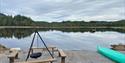 Campfire site by the water, with canoe