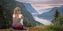 girl sitting on a rock in Rui Square and looking out over the Telemark Canal