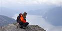 man enjoys the view from the top of Våmur, Fyresdal