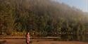 lady walks along the beach in Fyresdal