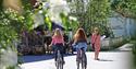 2 girls cycling along a street in Fyresdal